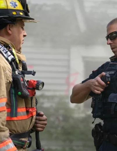 First responders using two-way radios for mission-critical public safety communication in the field