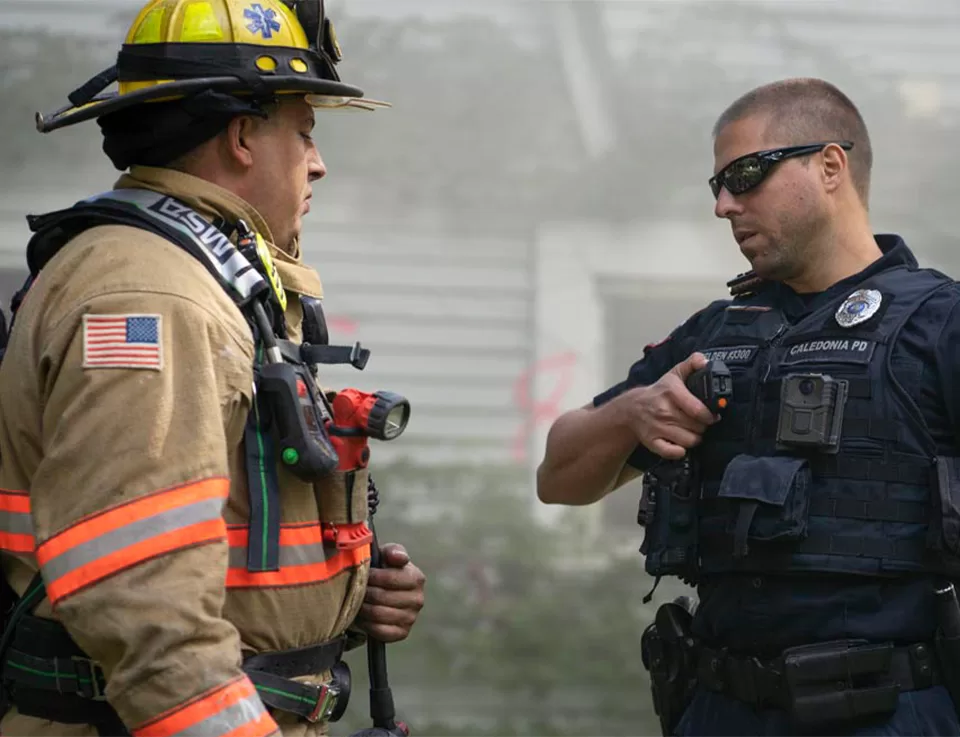 First responders using two-way radios for mission-critical public safety communication in the field