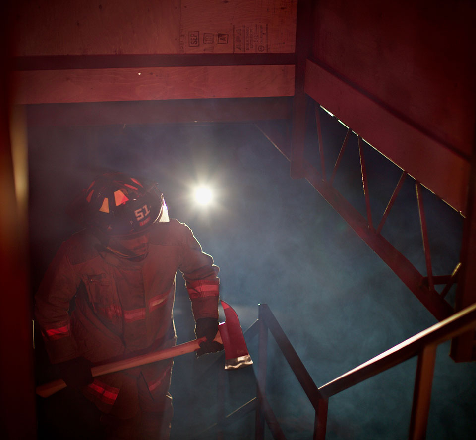 firefighter climbing staircase